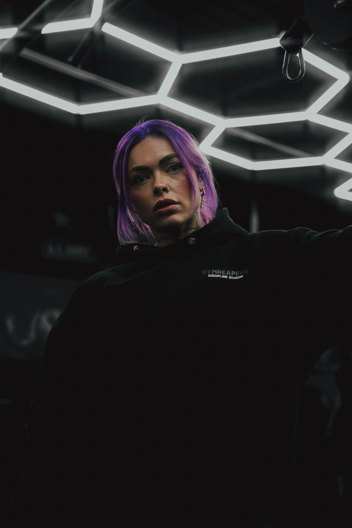Gymreapers athlete beneath geometric lighting