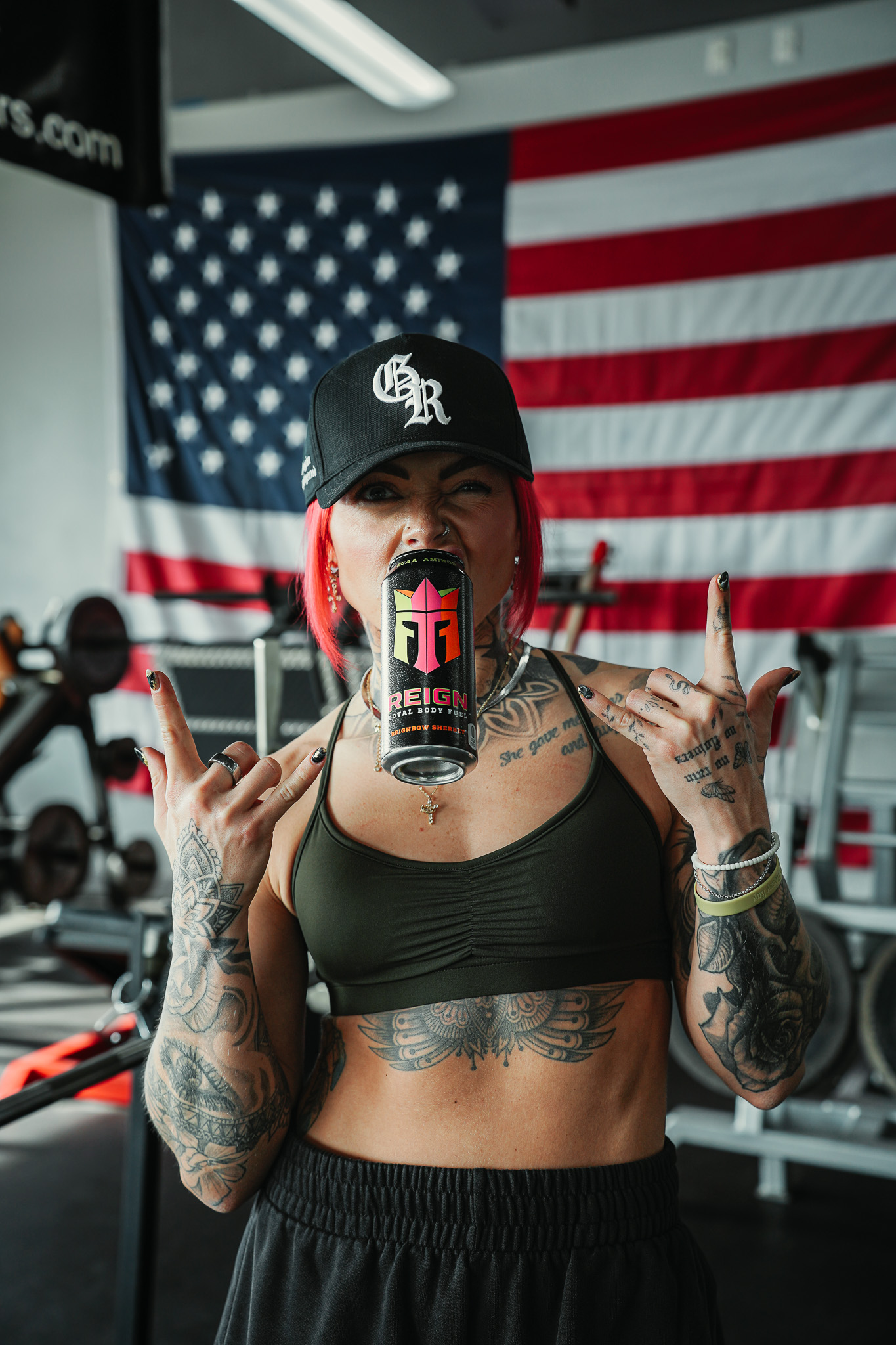 Reign athlete with a Reignbow Sherbet can in front of an American flag