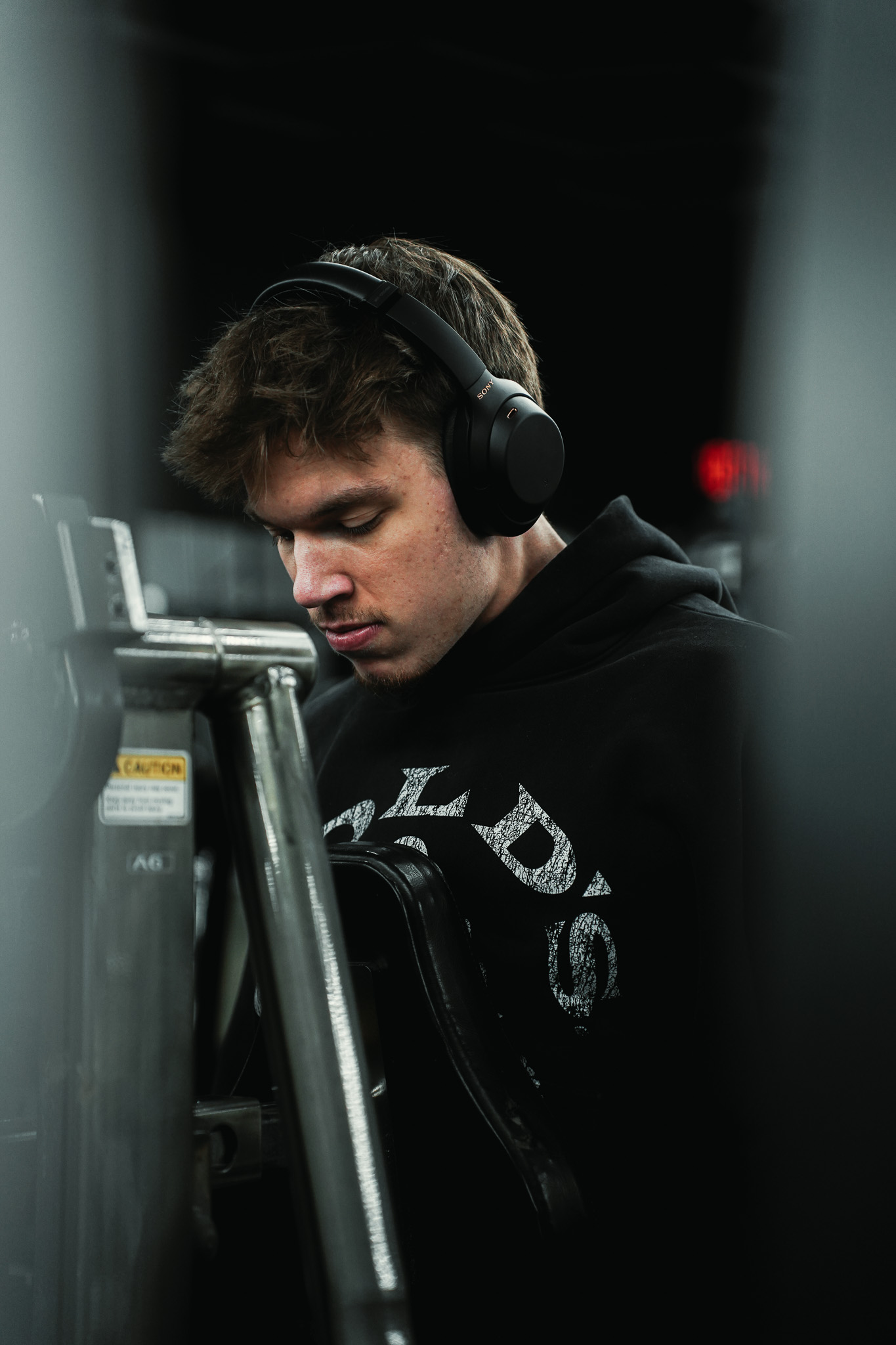 Athlete wearing headphones between machines