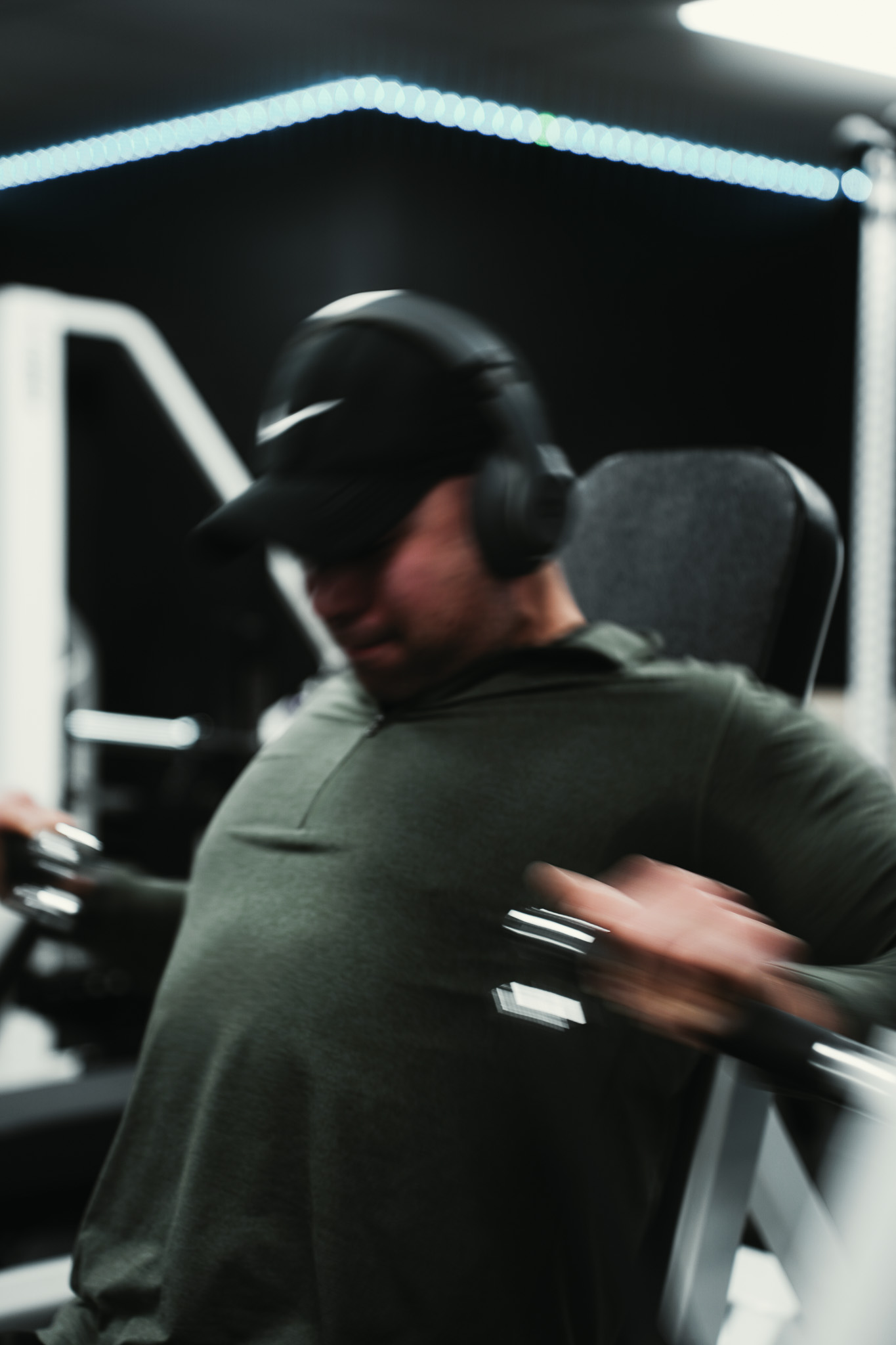 Athlete performing dumbbell raises with motion blur